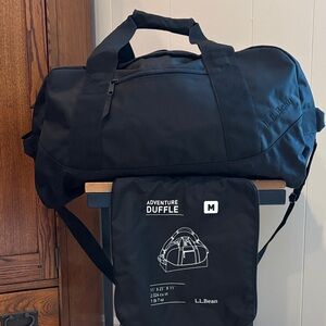 LLBean adventure duffle (Med.) black with carrying bag, padded shoulder strap